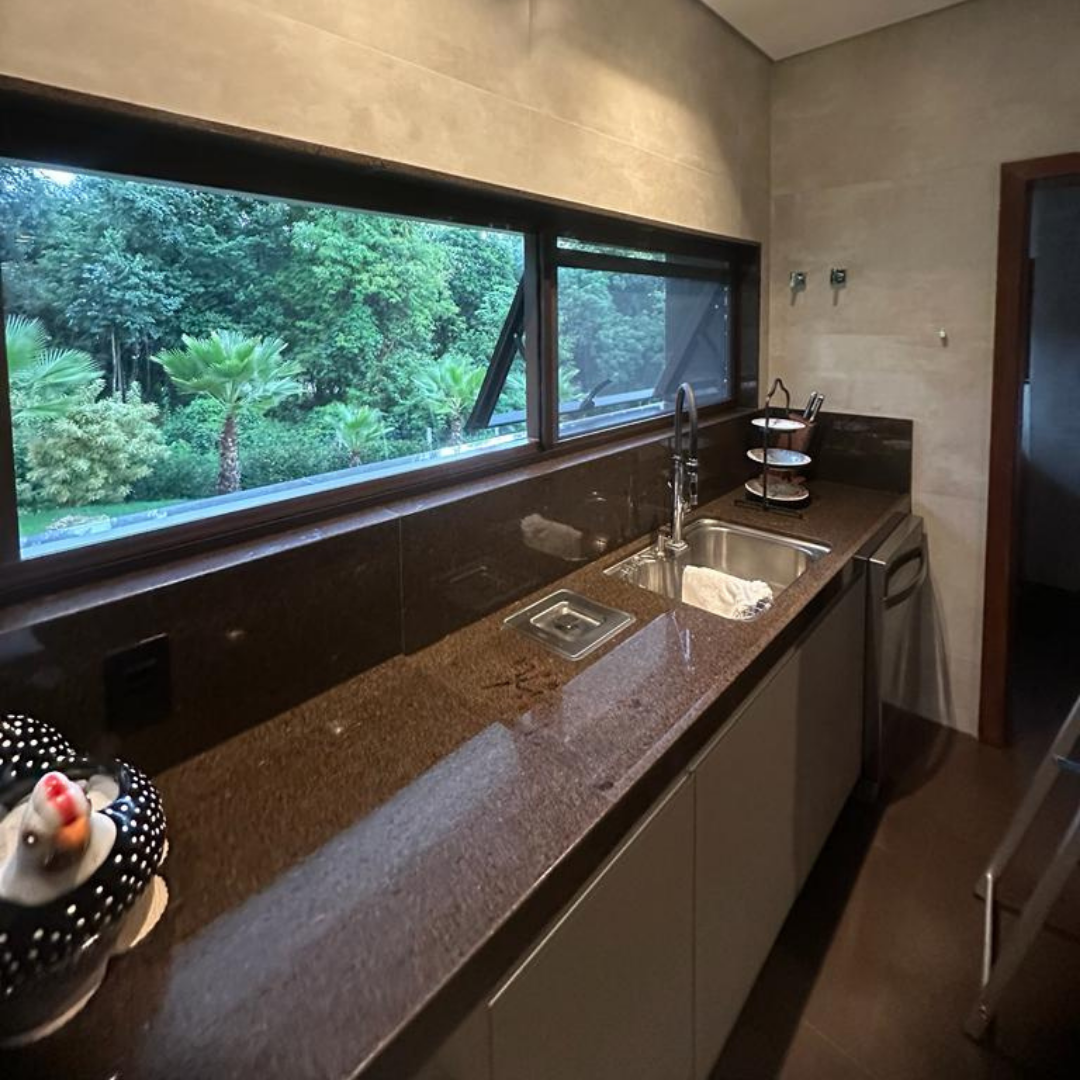 Tela mosquiteira instalada em janela de cozinha com vista para área verde — proteção contra insetos em BH